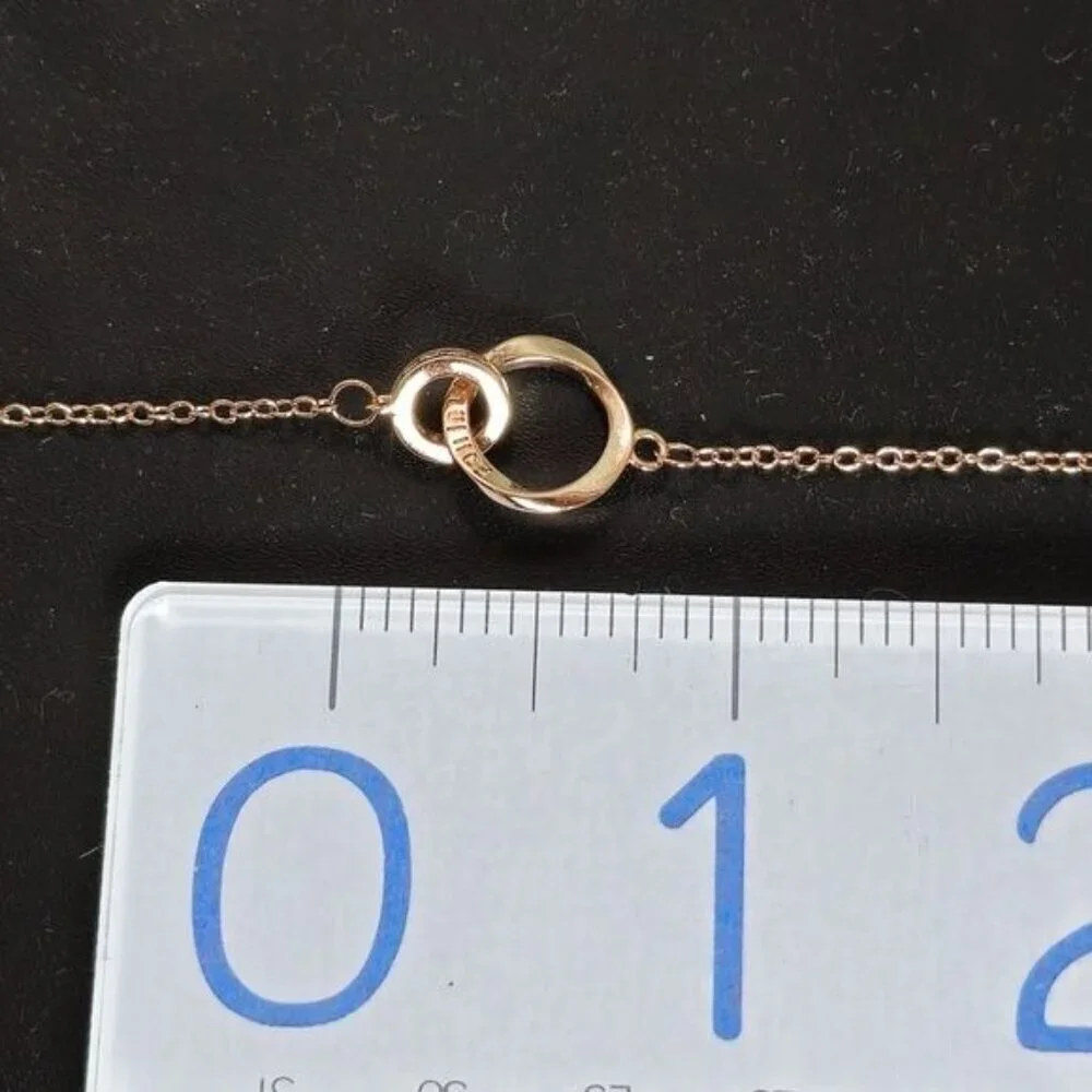 Interlocking Mobius Engraved Necklace‎ in Rose Gold (NWOT)